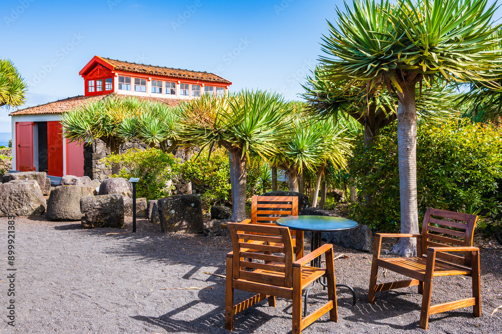 Chairs with table and historic traditional buildings in vineyard culture on Pico island, Azores, Portugal