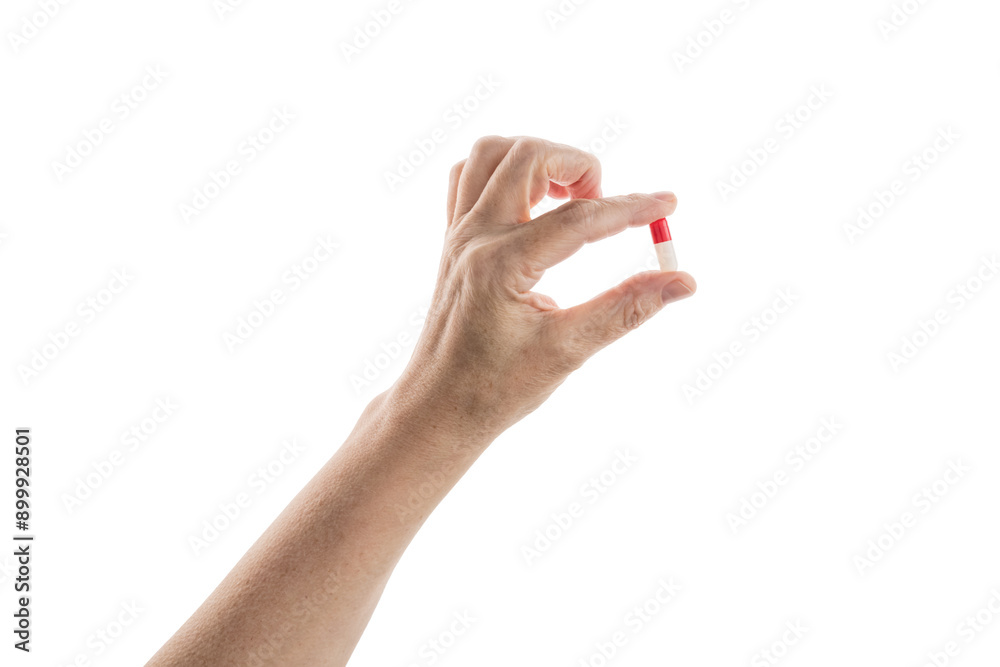 Mid aged female hold red and white pills isolated on white Mid aged female hold red and white pills isolated on white