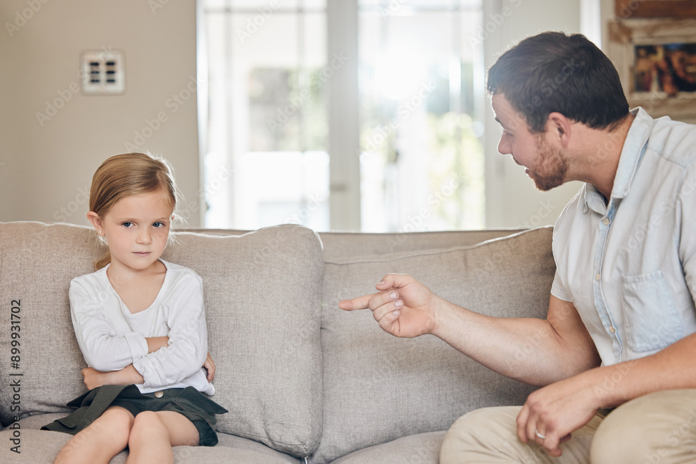 Obraz premium Upset, child and dad with discipline on sofa for bad behaviour, confrontation or punishment in living room. Home, disappointed and strict man pointing at young girl for fight, mistake or scolding