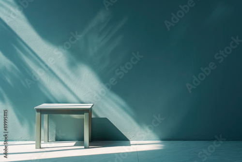 minimalist white bench against blue wall with shadow patterns photo