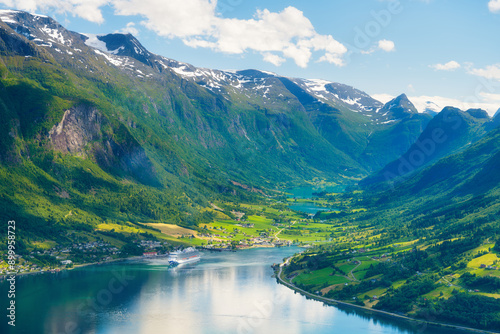 Obraz na płótnie Norway. Cruise ship in the Norwegian fjord. High mountains and reflections on the surface of the water. Clouds over the rocks. Vacation and travel in summer Norway. w salonie