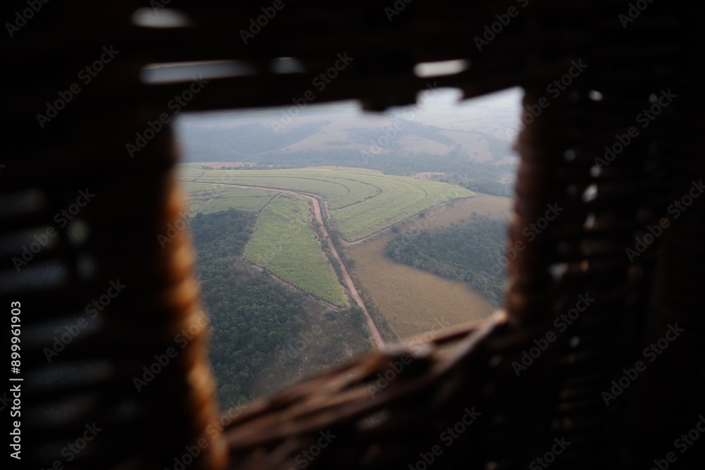 View of a road taken from a hot air balloon wicker basket hole View of a road taken from a hot air balloon wicker basket hole