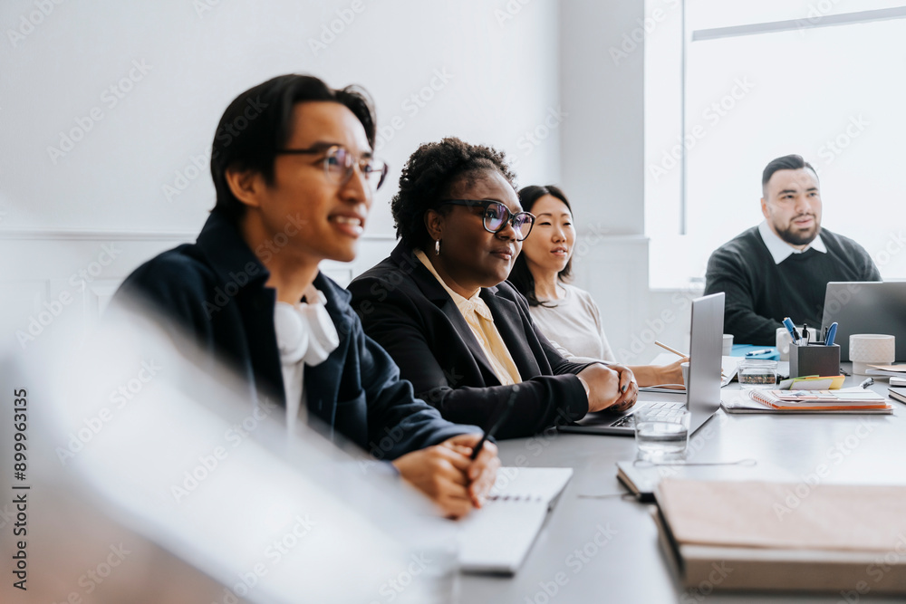 Male and female business professionals sitting in meeting at office Male and female business professionals sitting in meeting at office