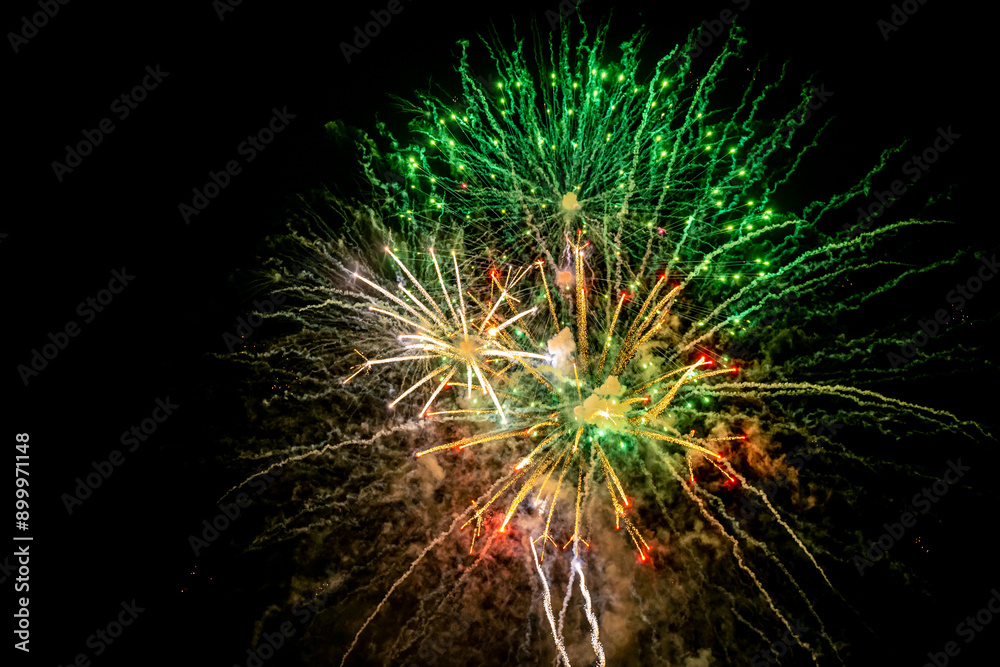 Holiday fireworks explode in the night sky. Selective focus. Holiday fireworks explode in the night sky. Selective focus.