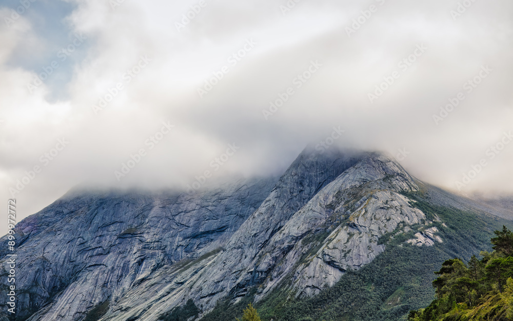 Moody mountain peak shrouded in mist. Ideal for nature, road trip and adventure articles and blogs . North Norway Moody mountain peak shrouded in mist. Ideal for nature, road trip and adventure articles and blogs . North Norway