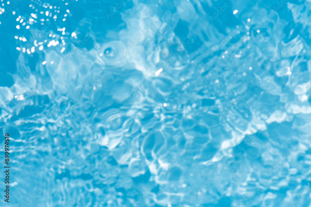 Blue water with ripples on the surface. Defocus blurred transparent blue colored clear calm water surface texture with splashes and bubbles. Water waves with shining pattern texture background. Blue water with ripples on the surface. Defocus blurred transparent blue colored clear calm water surface texture with splashes and bubbles. Water waves with shining pattern texture background.