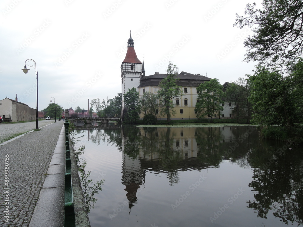 Obraz premium Blatna historical Gothic medieval water castle with towers and turrets, plus extensive grounds home to fallow deer and a cafe. 