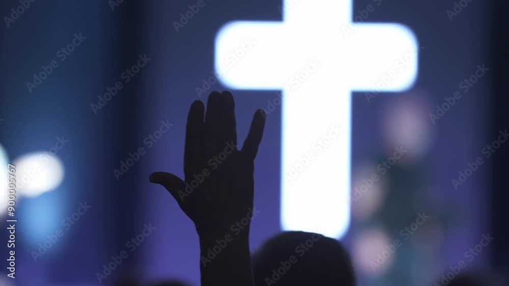 A man waving his hand in praise at a Christian church service