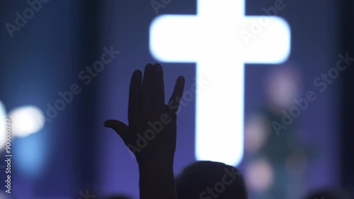 A man waving his hand in praise at a Christian church service