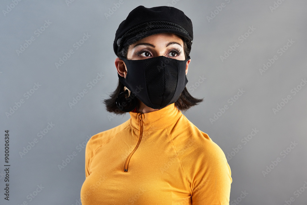 Woman, face mask and safety in studio for fashion, allergy and style with disease or virus. Gen z, college student and ideas or ppe for outfit, hat and problem solving for risk by gray background Woman, face mask and safety in studio for fashion, allergy and style with disease or virus. Gen z, college student and ideas or ppe for outfit, hat and problem solving for risk by gray background