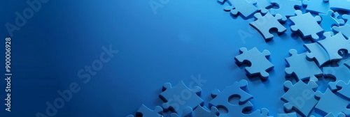 Scattered blue puzzle pieces on dark blue background. Concept of detail, fitting, and problem-solving.