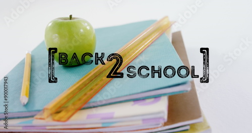 Image of back to school text over apple and school items