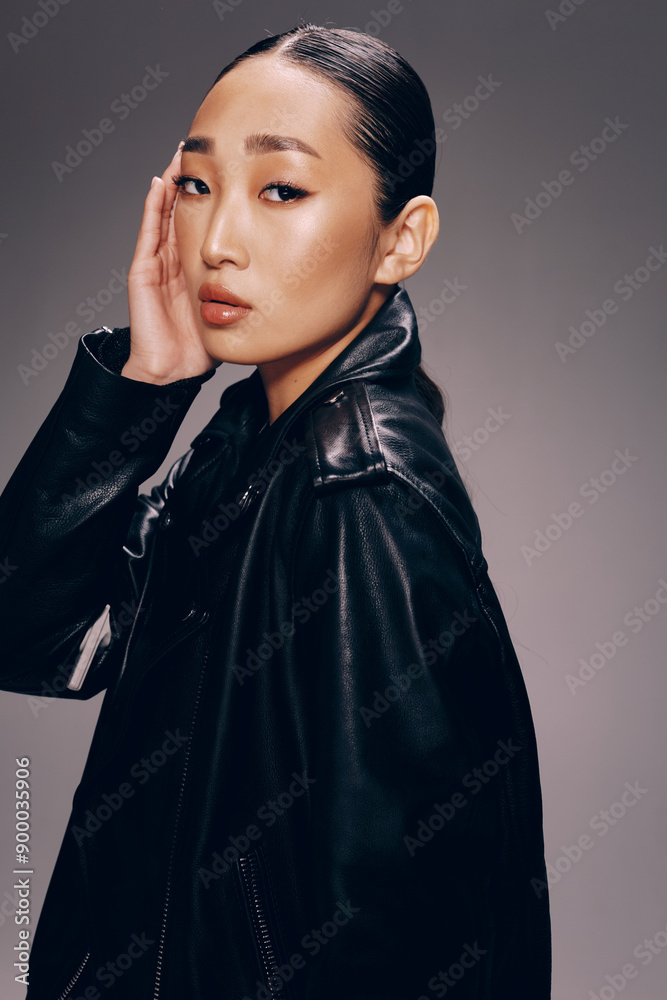 Asian woman, fashion, black leather jacket, posing, hands on face a stylish asian woman poses for the camera wearing a black leather jacket and with her hands on her face Asian woman, fashion, black leather jacket, posing, hands on face a stylish asian woman poses for the camera wearing a black leather jacket and with her hands on her face
