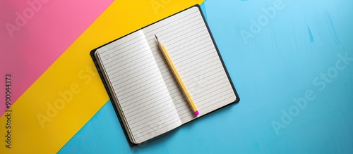 White notebook and pencil o...