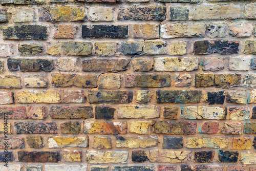 Brown and black grunge weathered brick wall, abstract full frame background texture with old dirty and vintage style pattern photo