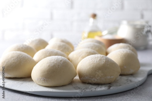 Raw dough balls on light grey table, closeup