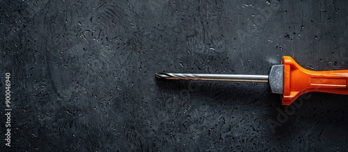 A screwdriver tool held aga...