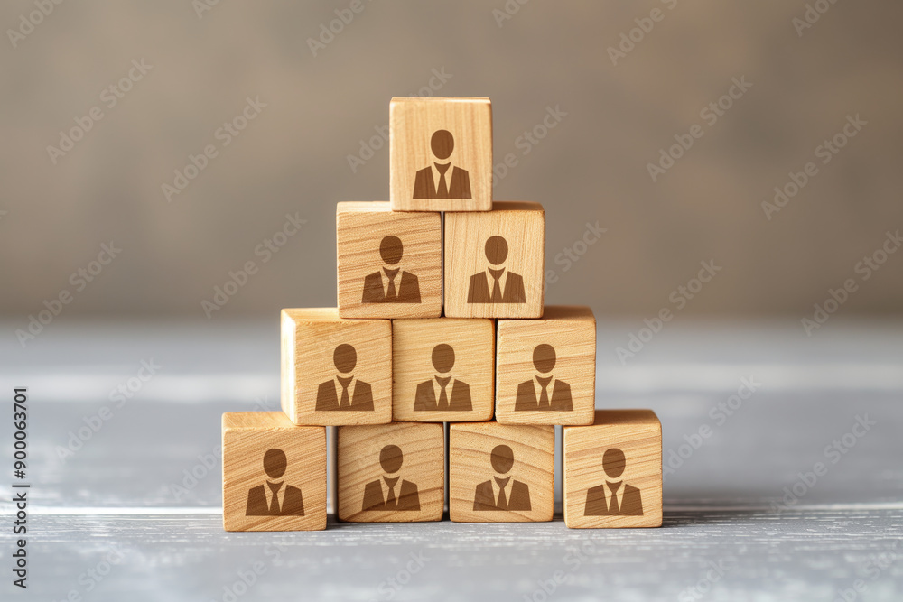 Wooden blocks with employee icons in pyramid formation, corporate hierarchy concept