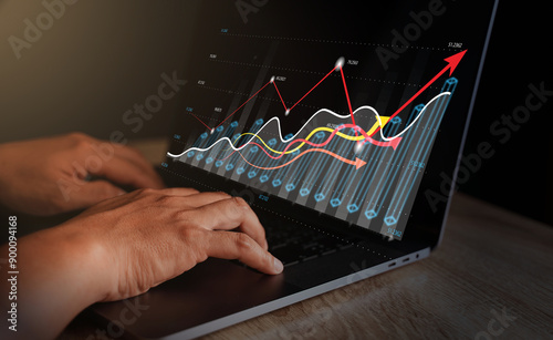 Businessmen using laptops to view company financial reports and graph showing financial growth data and figures. Concept, planning, strategy, analysis, growth, and profit in financial management.
