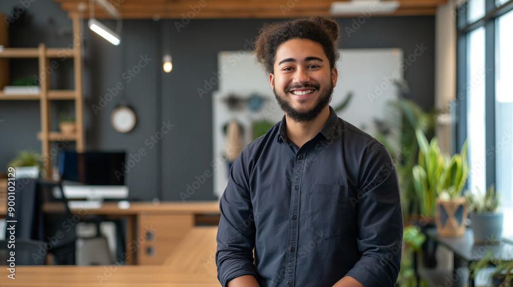 portrait of a smiling young man standing in modern office portrait of a smiling young man standing in modern office