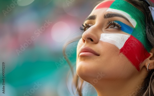 Woman with face paint at soccer stadium.