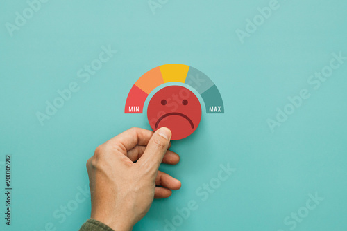 Service rating, satisfaction and negative feedback. A man choose bad face emoticon give a one star rating indicates the lowest level of satisfaction with the service