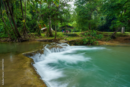 camping tent on nature waterfall and motion flow stream water in green trees forest for summer holiday relax and vacation travel with trekking picnic at Huai Mae Khamin Waterfall campground Thailand