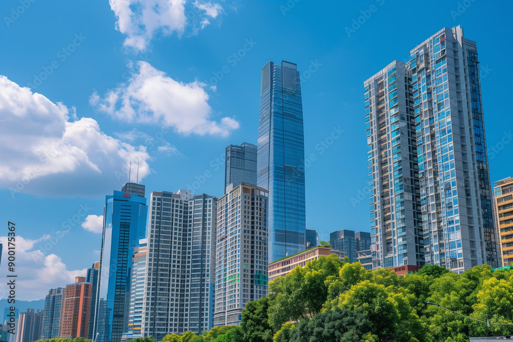 Skyscrapers Reaching into a Bright Blue Sky with White Clouds on a Sunny Day Skyscrapers Reaching into a Bright Blue Sky with White Clouds on a Sunny Day