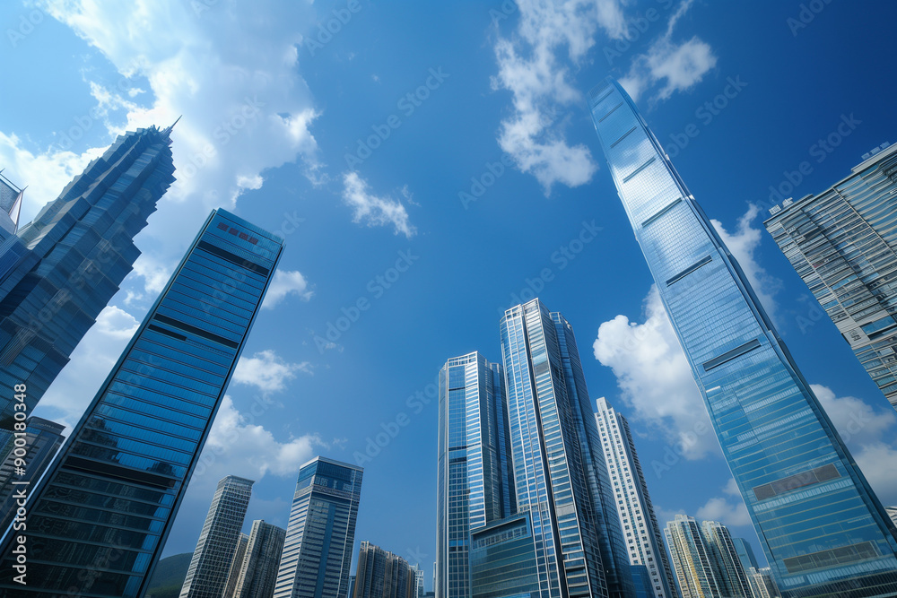 Skyscrapers Reaching into a Bright Blue Sky with White Clouds on a Sunny Day Skyscrapers Reaching into a Bright Blue Sky with White Clouds on a Sunny Day
