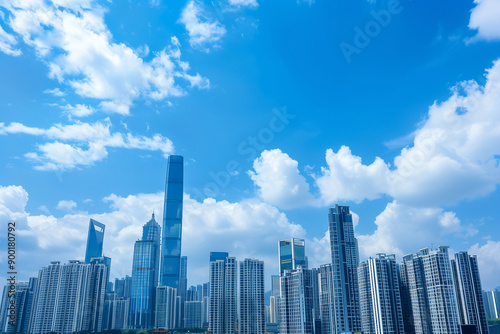 Skyscrapers Reaching into a Bright Blue Sky with White Clouds on a Sunny Day