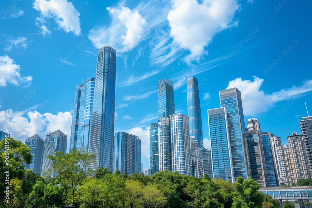 Skyscrapers Reaching into a Bright Blue Sky with White Clouds on a Sunny Day Skyscrapers Reaching into a Bright Blue Sky with White Clouds on a Sunny Day