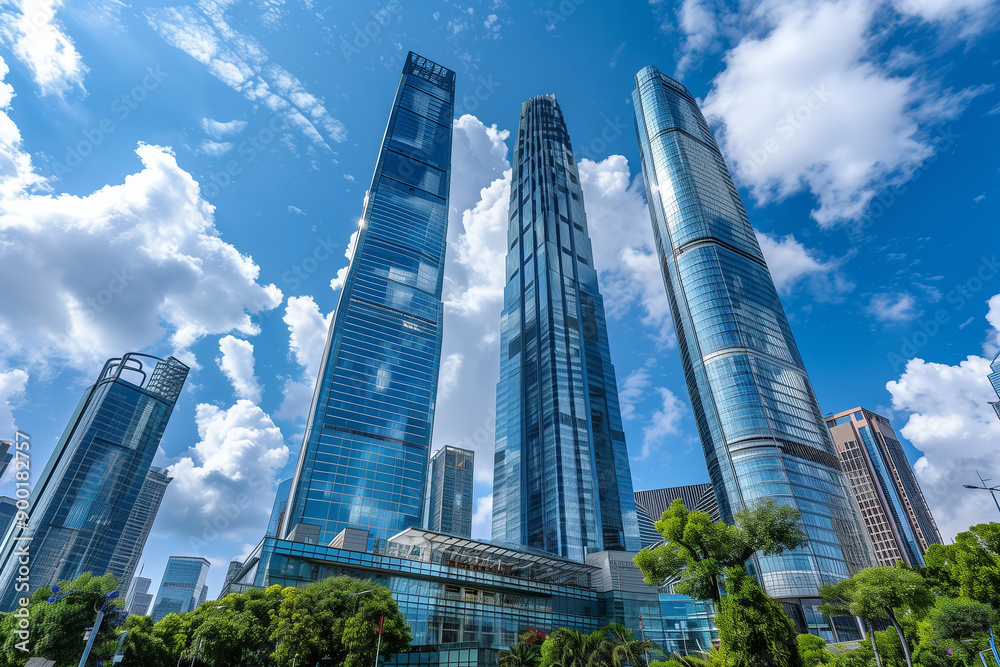 Skyscrapers Reaching into a Bright Blue Sky with White Clouds on a Sunny Day Skyscrapers Reaching into a Bright Blue Sky with White Clouds on a Sunny Day