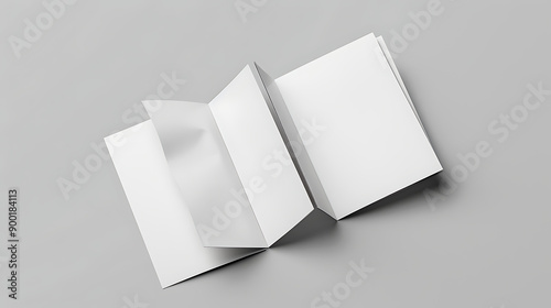 Open and closed blank brochures on grey background, top view. Mock up for design