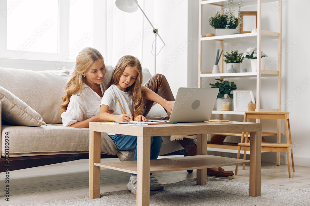 Mother and daughter bonding time on the couch while browsing the internet on a laptop in a cozy living room Mother and daughter bonding time on the couch while browsing the internet on a laptop in a cozy living room