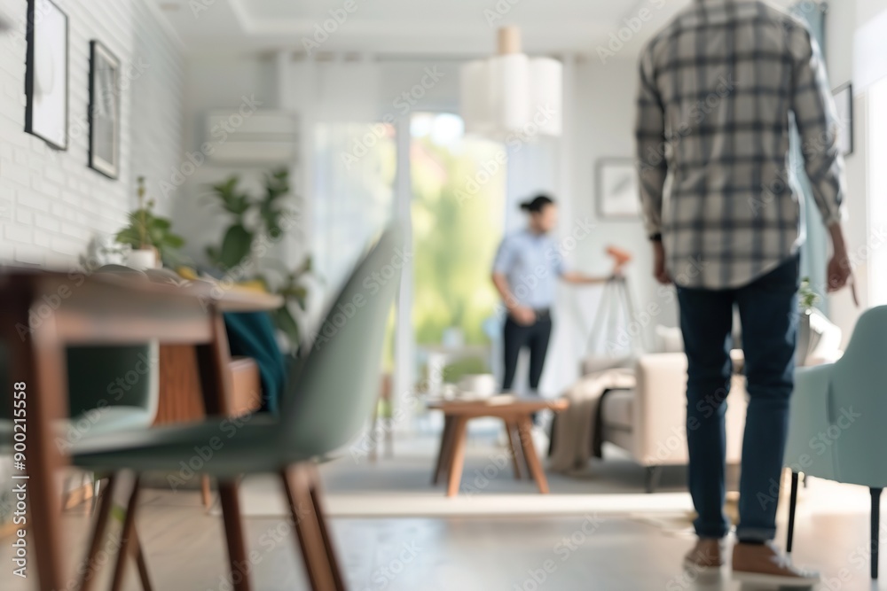 Blurred view of people in modern living room, focus on furniture Blurred view of people in modern living room, focus on furniture
