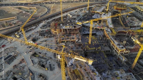 Drone view of Mega construction of Saudi Arabia on the sunset with plenty of cranes 