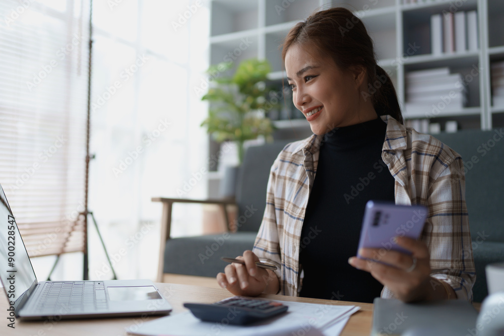 Smart Mortgage Planning woman using a calculator to make Calculations and Consideration Smart Mortgage Planning woman using a calculator to make Calculations and Consideration