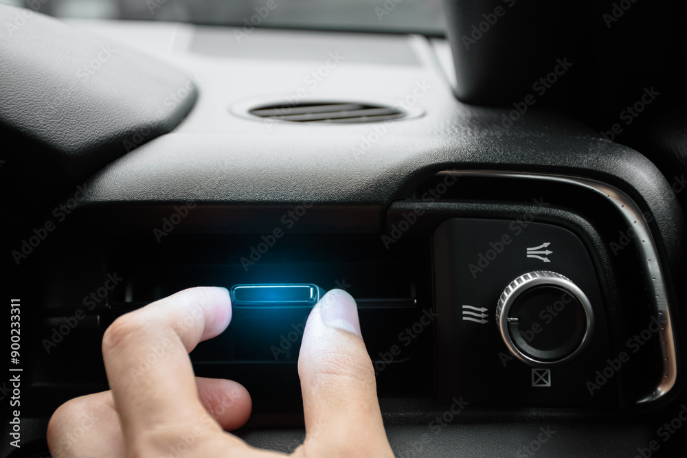 The driver hand adjusts the wind direction of the air vent in the modern car, button direction adjustment of the air conditioning system in the car, Automotive air conditioning concept 2024. The driver hand adjusts the wind direction of the air vent in the modern car, button direction adjustment of the air conditioning system in the car, Automotive air conditioning concept 2024.