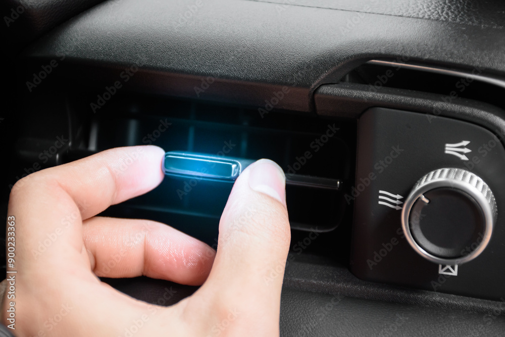 The driver hand adjusts the wind direction of the air vent in the modern car, button direction adjustment of the air conditioning system in the car, Automotive air conditioning concept 2024. The driver hand adjusts the wind direction of the air vent in the modern car, button direction adjustment of the air conditioning system in the car, Automotive air conditioning concept 2024.