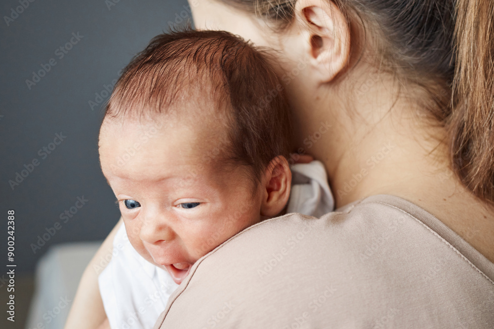 Unrecognizable young mom cradling her healthy newborn daughter expressing love and happiness, enjoying the early days of motherhood and bond with her child Unrecognizable young mom cradling her healthy newborn daughter expressing love and happiness, enjoying the early days of motherhood and bond with her child