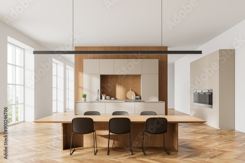 Cozy home kitchen interior with dining table andh chairs, cabinet and window photo