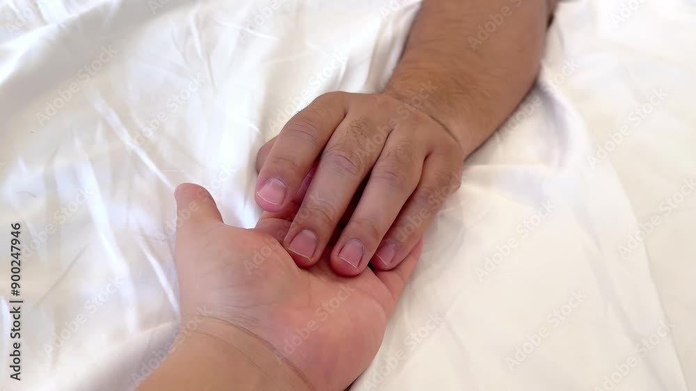 Close up of couple hands on bed relaxing in bedroom - lovers have intense sex or making love feeling orgasm and satisfaction. High quality 4k footage Close up of couple hands on bed relaxing in bedroom - lovers have intense sex or making love feeling orgasm and satisfaction. High quality 4k footage