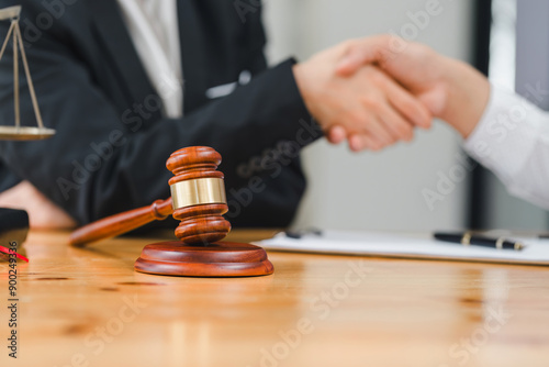 Law and justice concept, businessman shaking hands with lawyer to seal agreement with lawyer, partner or lawyer discussing contract agreement The concept of holding hands.