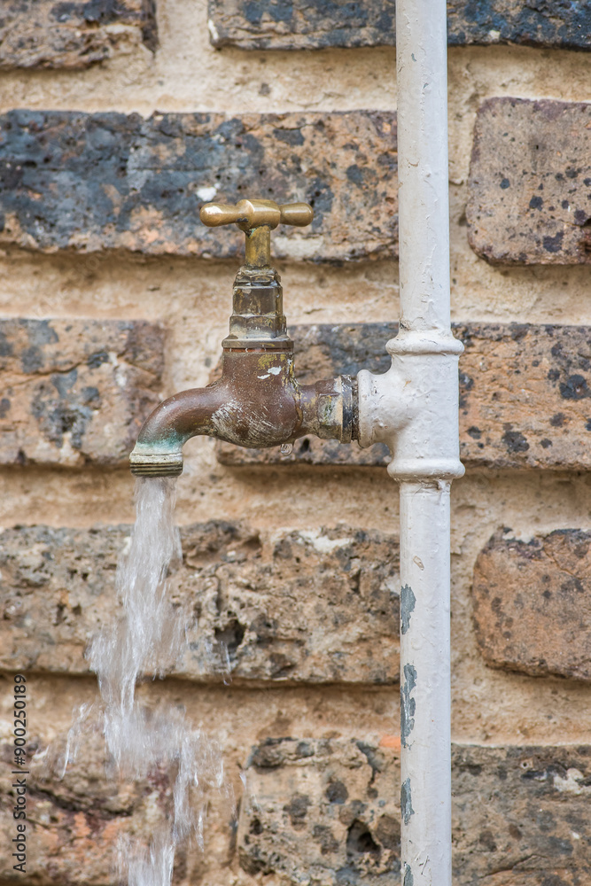 Water running from an open tap Water running from an open tap