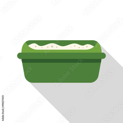 Green plastic litter box filled with absorbent cat litter on white background