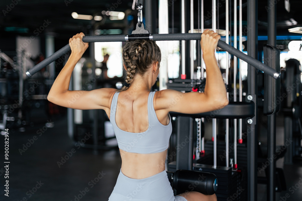 Attractive sport woman with beautiful figure is engaged in gym. Upper block thrust. Healthy lifestyle. Attractive sport woman with beautiful figure is engaged in gym. Upper block thrust. Healthy lifestyle.