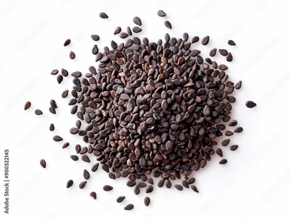 Black sesame seeds are scattered on a white background, highlighting their distinct texture and color Black sesame seeds are scattered on a white background, highlighting their distinct texture and color