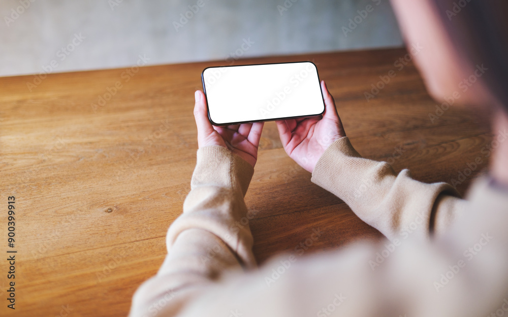 Mockup image of a woman holding mobile phone with blank desktop screen Mockup image of a woman holding mobile phone with blank desktop screen