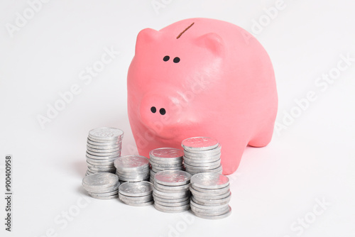 Pink piggy bank and stack of coins isolated on white background. Investment budget savings wealth business retirement, finance, money, banking concept. copy space