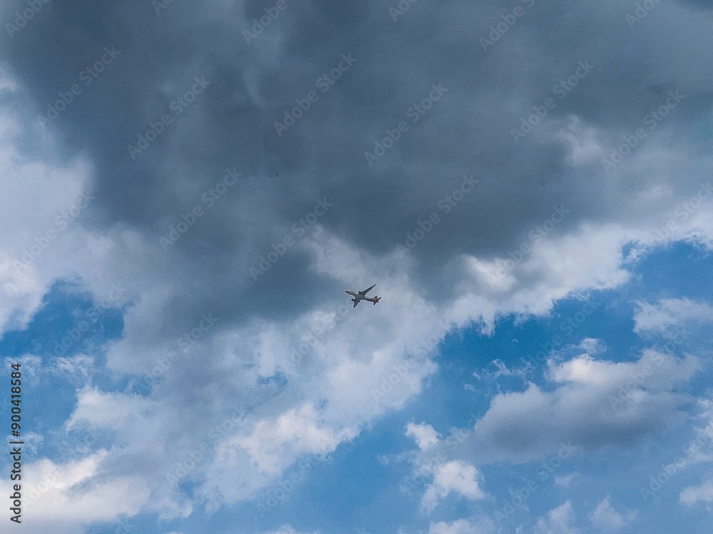 Distant Wings Under a Lilac Sky - A lone airplane soars through a serene sky painted with soft lilac and white clouds